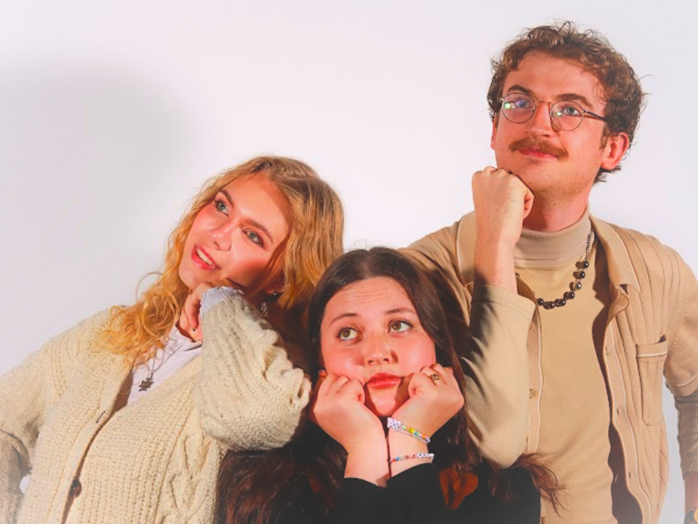 Three individuals (left to right: Samantha Frew, Chiara Power, and Jack Storwick) pose quizzically together, staring into the middle distance.